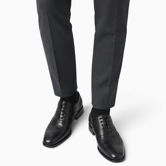 Elegant handmade brogue shoes showcasing intricate craftsmanship and classic design for refined style.