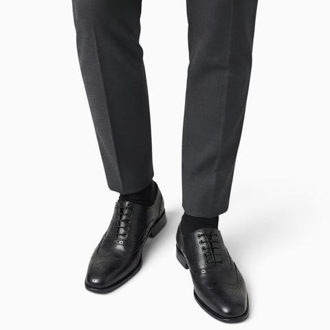 Elegant handmade brogue shoes showcasing intricate craftsmanship and classic design for refined style.