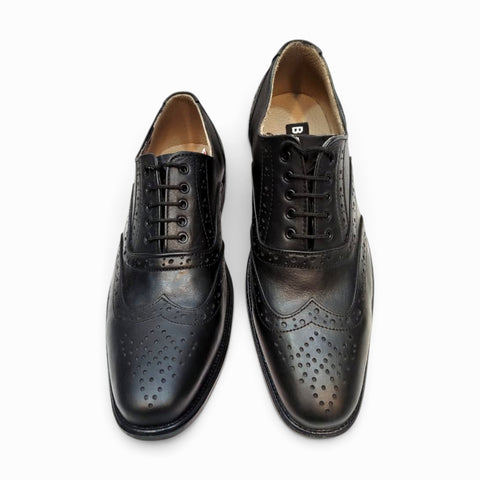 Elegant handmade brogue shoes showcasing intricate craftsmanship and classic design for refined style.